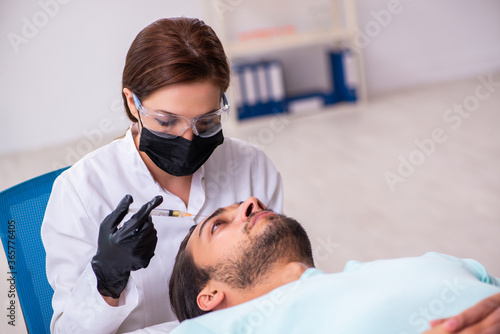 Young man visiting female beautician in hair transplantation con