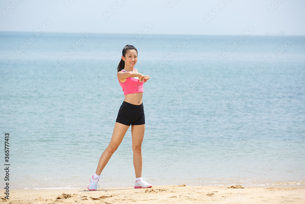 Young Asian woman doing exercise outdoors