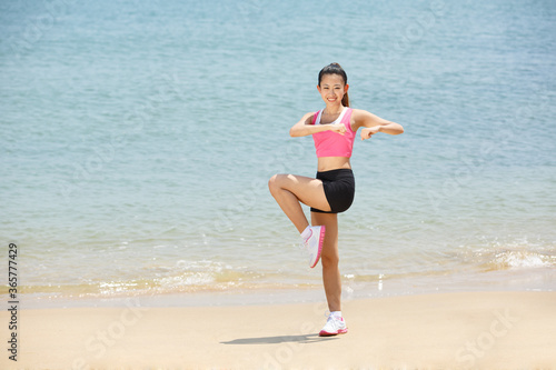 Young Asian woman doing exercise outdoors