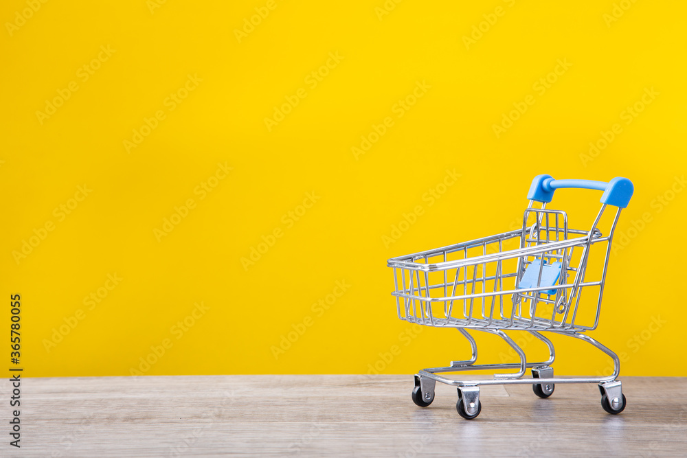  shopping trolley on yellow background