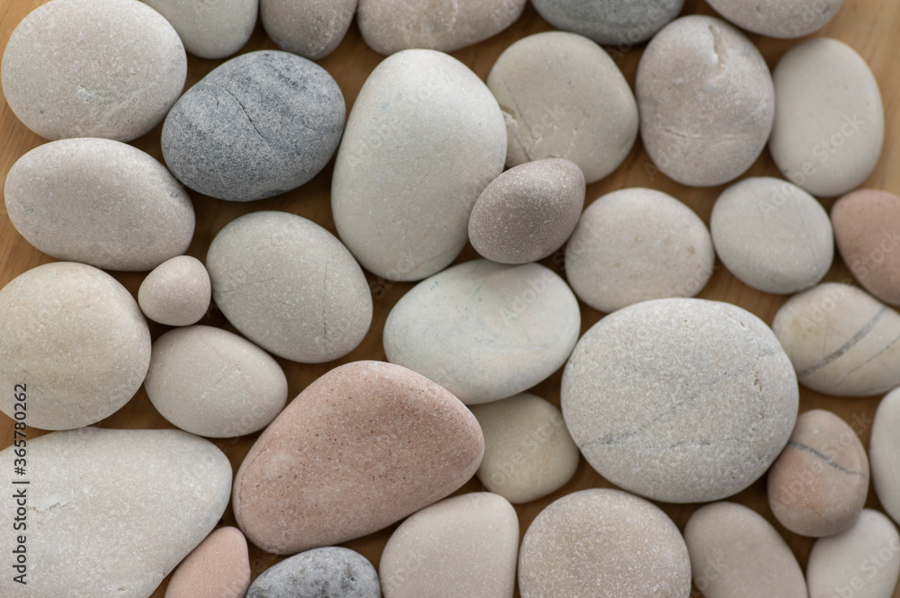 White, gray and pink pebbles simple background, simplicity stones one by one White, gray and pink pebbles simple background, simplicity stones one by one