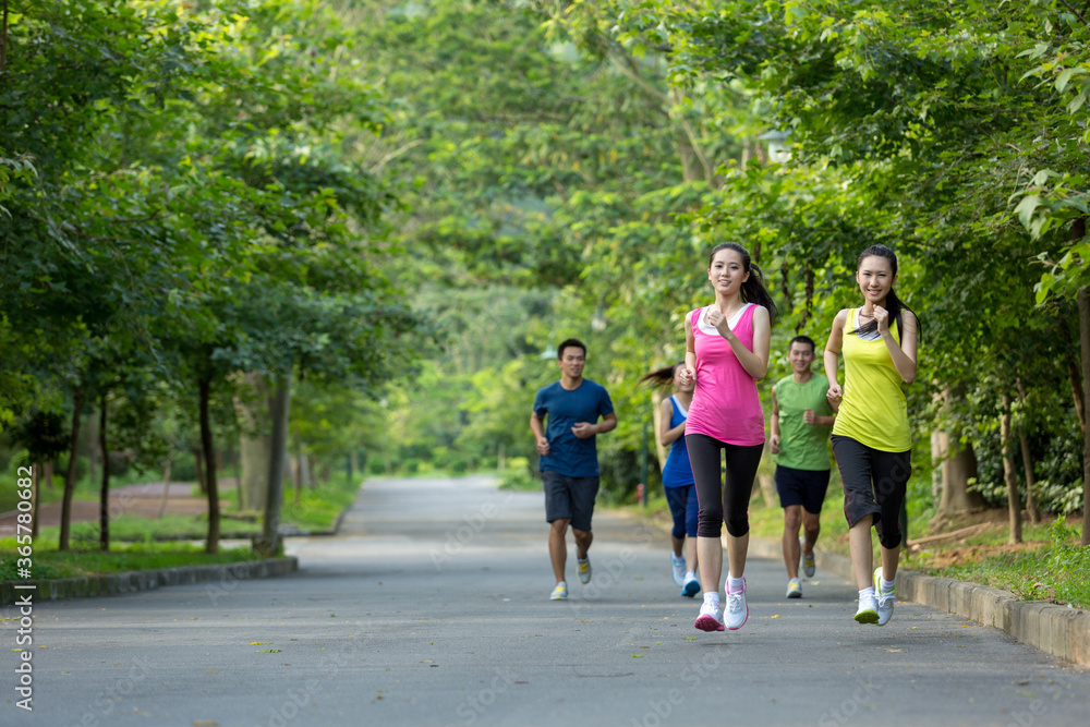 Group of friends running together outdoors