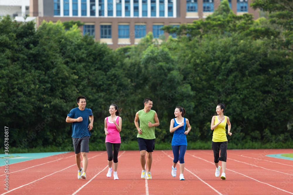 Fototapeta premium Group of friends running together outdoors