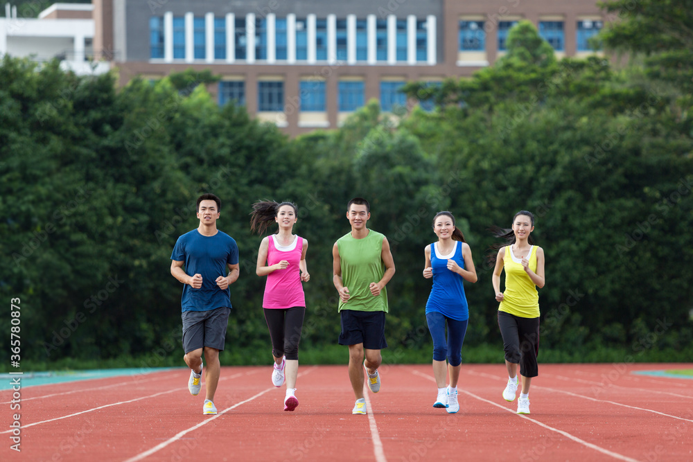 Fototapeta premium Group of friends running together outdoors