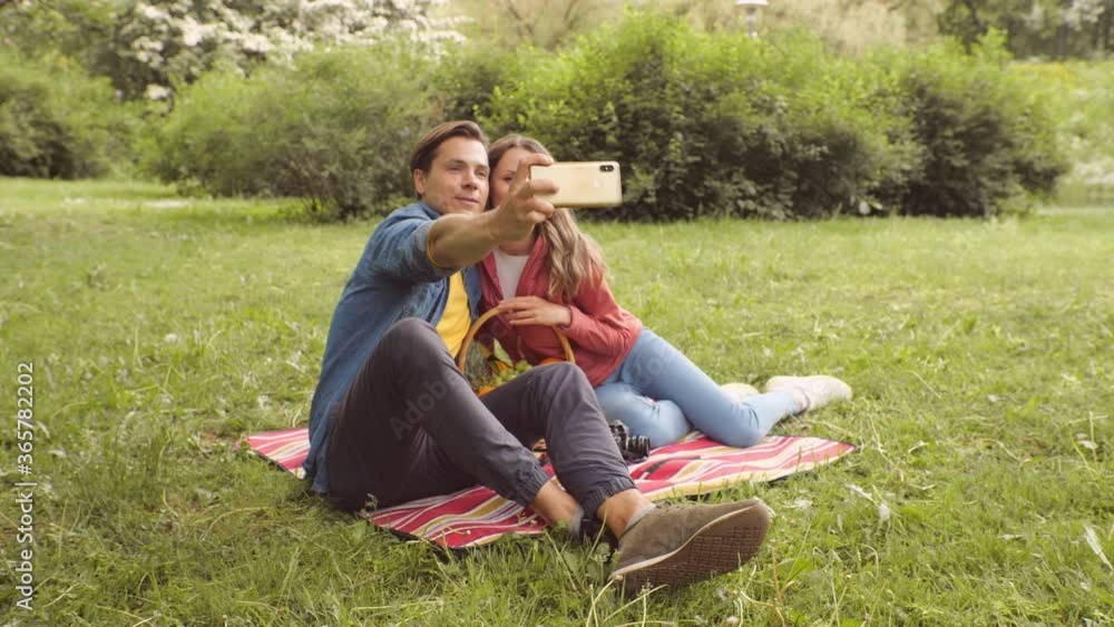 Young, happy, loving couple having date in the park. Relations, friendship and love. Young, happy, loving couple having date in the park. Relations, friendship and love.