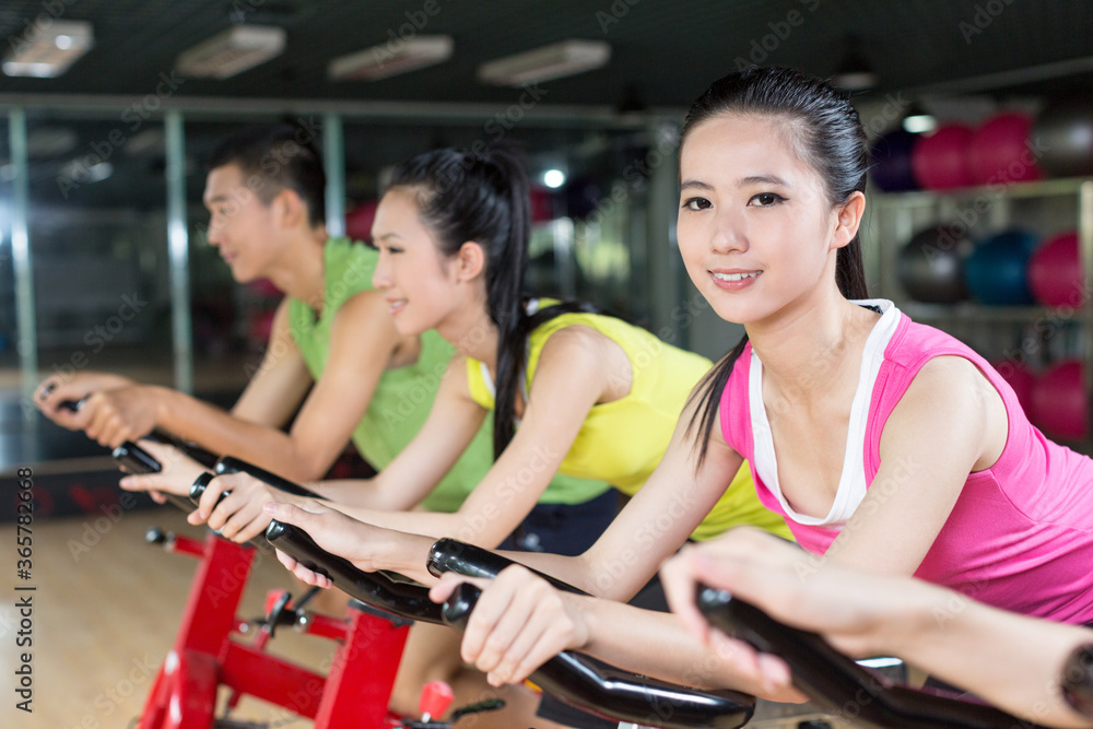 Group of young people spinning in the gym Group of young people spinning in the gym