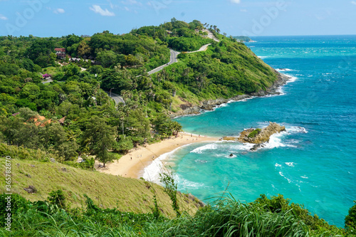 Panoramic view of Thai beach, Phuket, Thailand. Tropical white sandy and tranquil beach with turquoise clear water and palm trees background with blue sky colony of Laem Singh beach nearby Surin beach