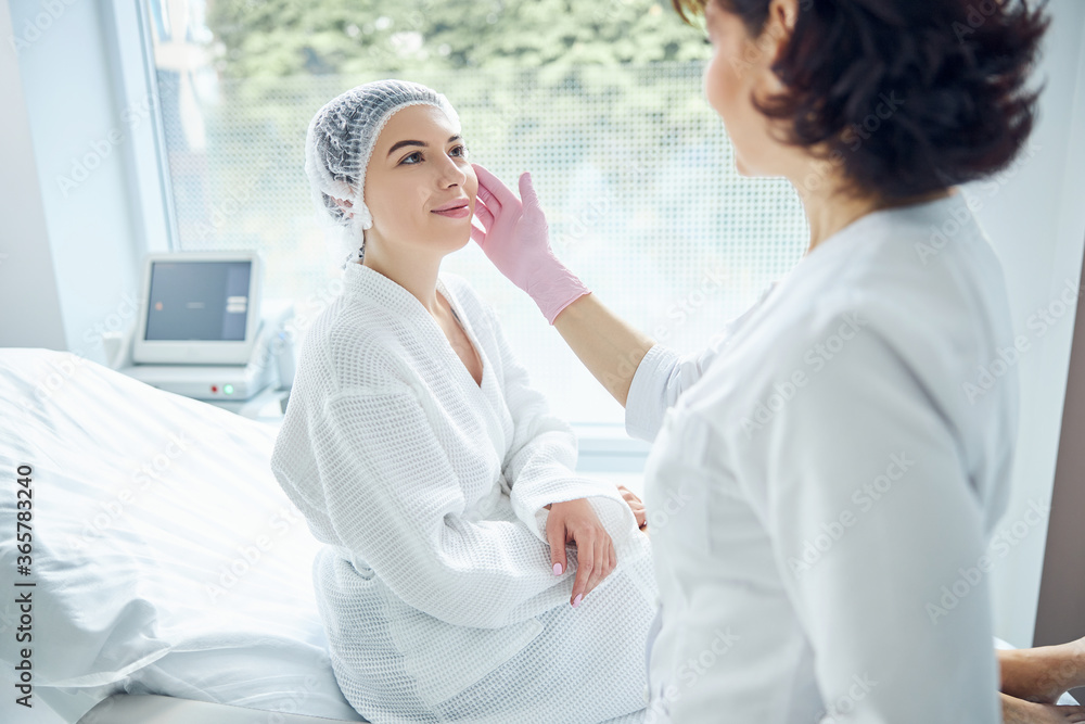 Fototapeta premium Delighted young woman attending professional cosmetic studio