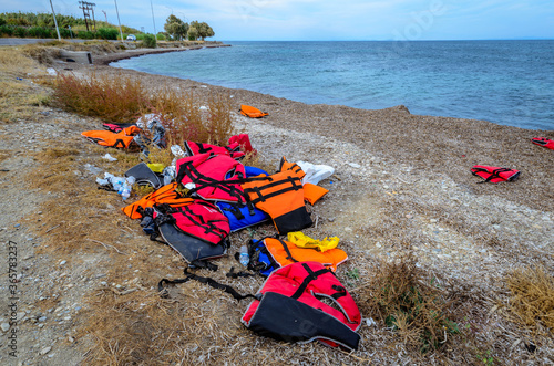 Lesvos Greece- Lifejackets left by refugees on the shore of Mytilini. photo