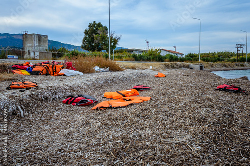 Schilderij op canvas Lesvos Greece- Lifejackets left by refugees on the shore of Mytilini