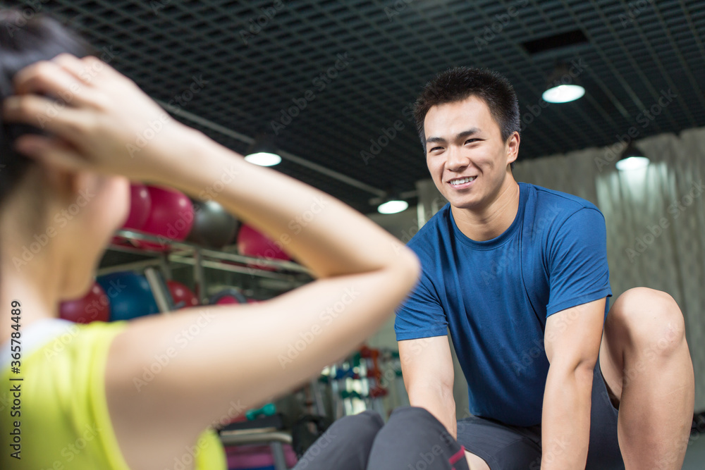 Professional fitness coach training fit woman in the gym Professional fitness coach training fit woman in the gym