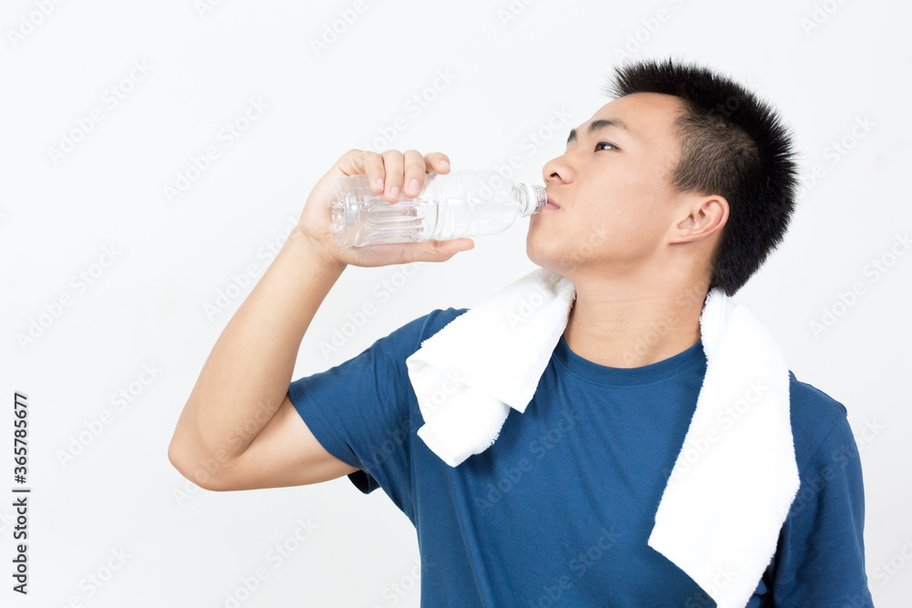 Young Asian man drinking water after sports Young Asian man drinking water after sports