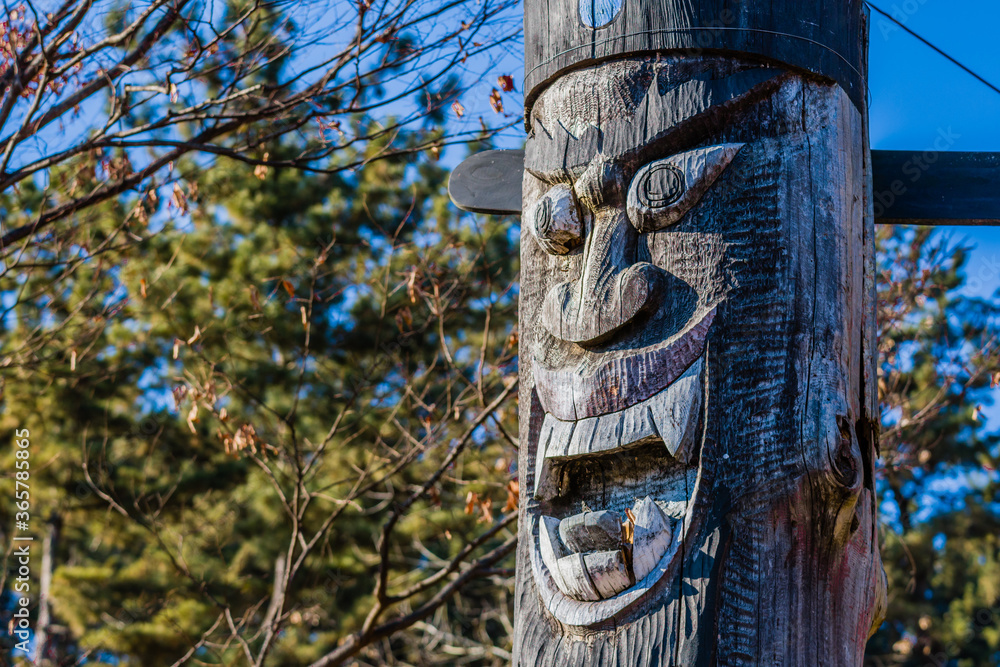 Carved face of wooden totem pole Carved face of wooden totem pole