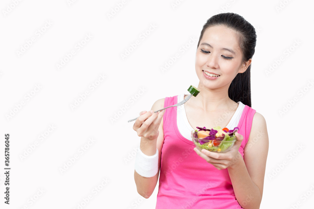 Young Asian woman eating salad after exercise in the gym Young Asian woman eating salad after exercise in the gym