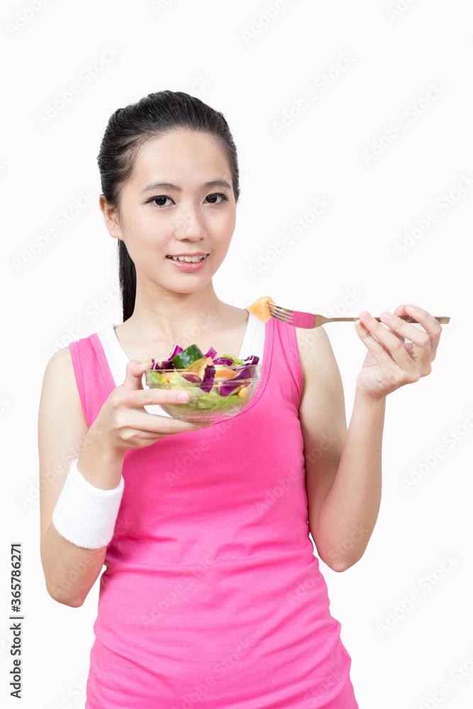 Young Asian woman eating salad after exercise in the gym Young Asian woman eating salad after exercise in the gym