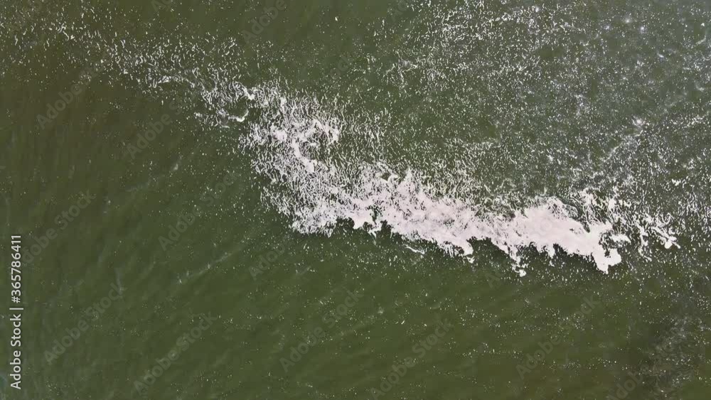 Ocean shore with rolling waves, view from a height Ocean shore with rolling waves, view from a height
