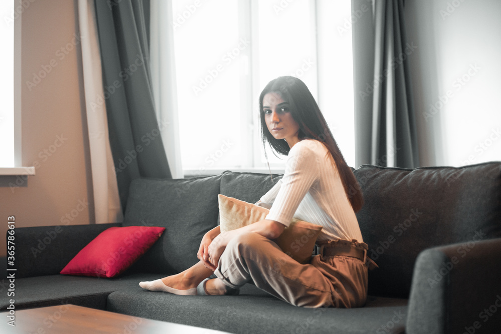 Young woman pretty relaxing on couch in living room Young woman pretty relaxing on couch in living room