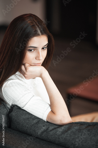 Young woman pretty relaxing on couch in living room © VERSUSstudio