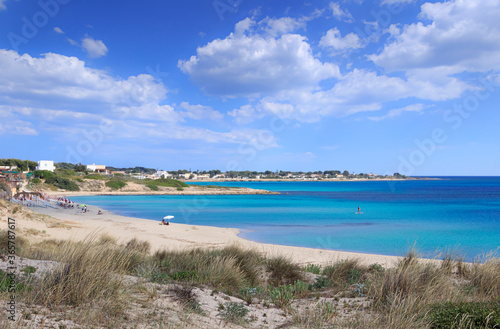 The most beautiful beaches of Puglia: Marina di Lizzano beach (Taranto). The coastline is characterized by a alternation of sandy coves and jagged cliffs overlooking a truly clear and crystalline sea. photo