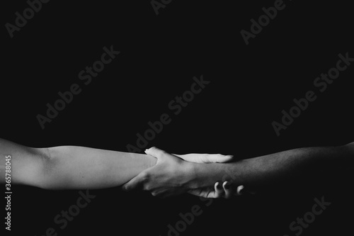 white and black hand together
