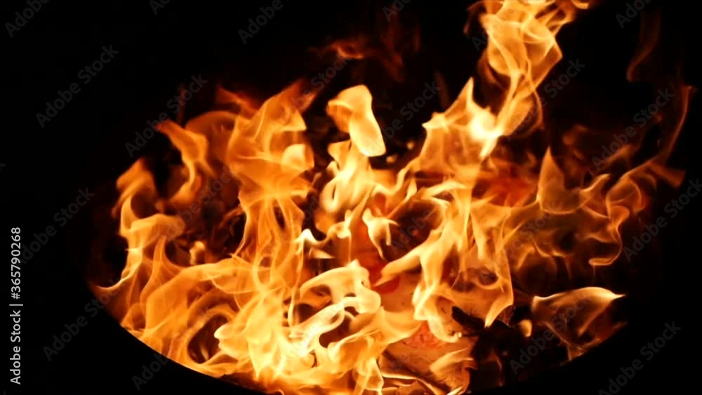 Fire burns wood in the metal bin, slow motion HD Fire burns wood in the metal bin, slow motion HD