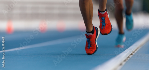 Athletes sprinters run speed on track of stadium 
