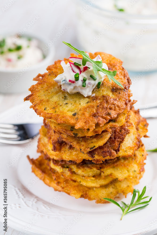 Fried potato pancake with dip of radishes cream cheese and chives