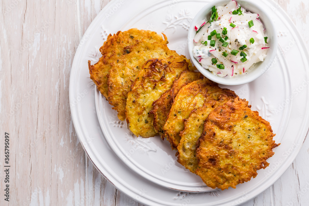 Fried potato pancake with dip of radishes cream cheese and chives Fried potato pancake with dip of radishes cream cheese and chives