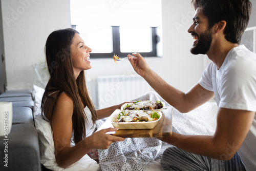 Romantic happy couple having breakfast in bed