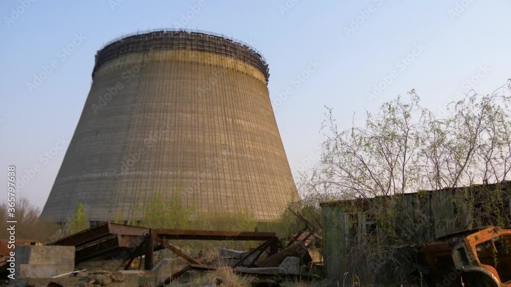 Remains of equipment contaminated with radiation, metal, concrete structures on the territory of Chernobyl zone after the disaster. Cooling tower of Chernobyl NPP, Chernobyl Exclusion Zone, Ukraine.