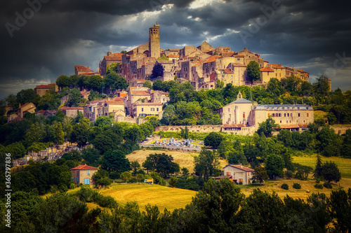 The village of Cordes sur Ciel  Tarn region of France  on a stormy day with late afternoon sunlight