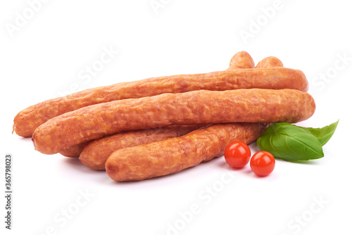 Dried pork sausages with basil leaves, isolated on a white background. Close-up. photo