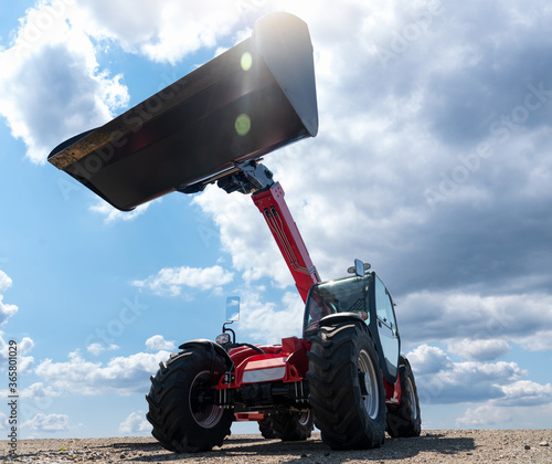 Fotografija Telescopic loader against the blue sky