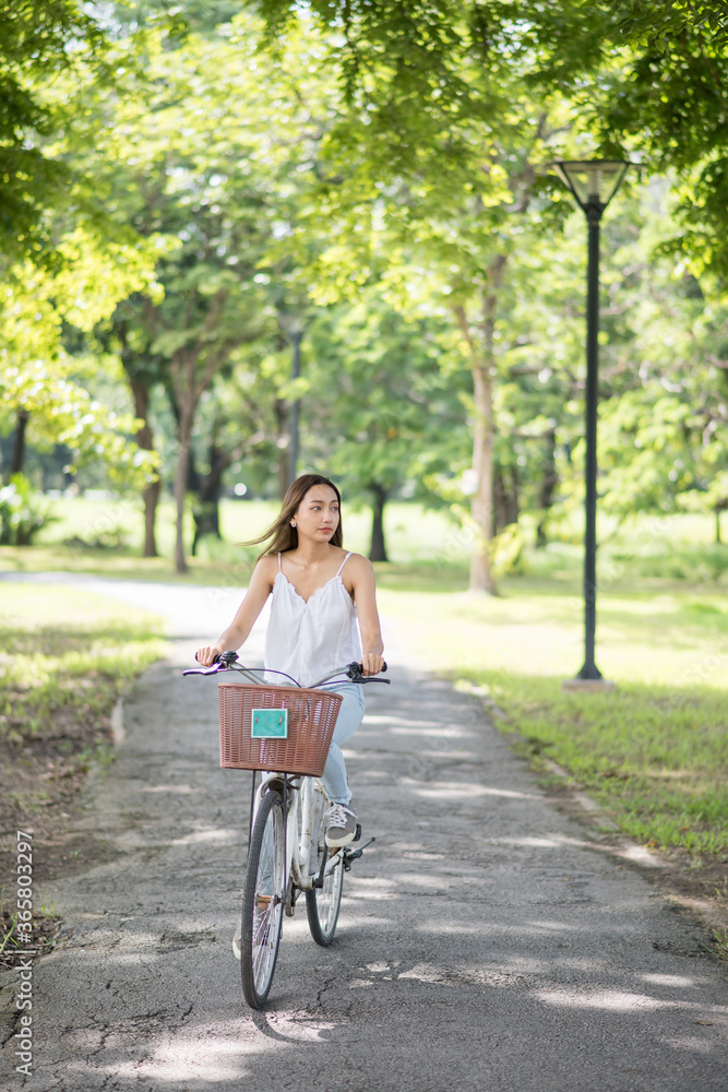 Beauty teenage woman bike in urban park Beauty teenage woman bike in urban park