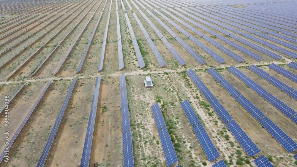 Circle flight of a drone over a modern field of alternative energy, solar panels. Large area with solar panels. Modern power plant of green energy. The future of safe technology. Circle flight of a drone over a modern field of alternative energy, solar panels. Large area with solar panels. Modern power plant of green energy. The future of safe technology.