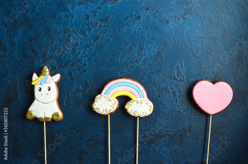 Sweet dessert for children's holiday table. Children's gingerbread in the shape of a unicorn, rainbow and heart with space for text 
