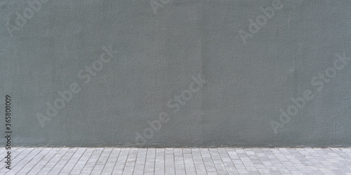 dark gray concrete wall exterior with empty space for mockup over block cement pavement outdoor