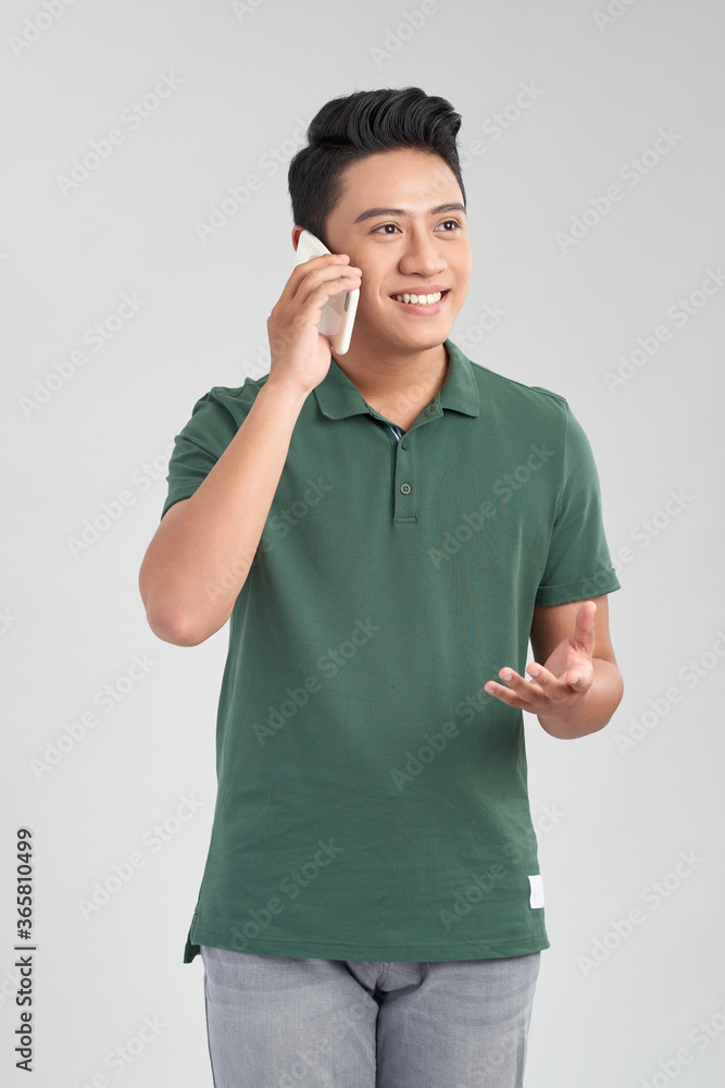 Happy smiling young man talking on mobile isolated on white background Happy smiling young man talking on mobile isolated on white background