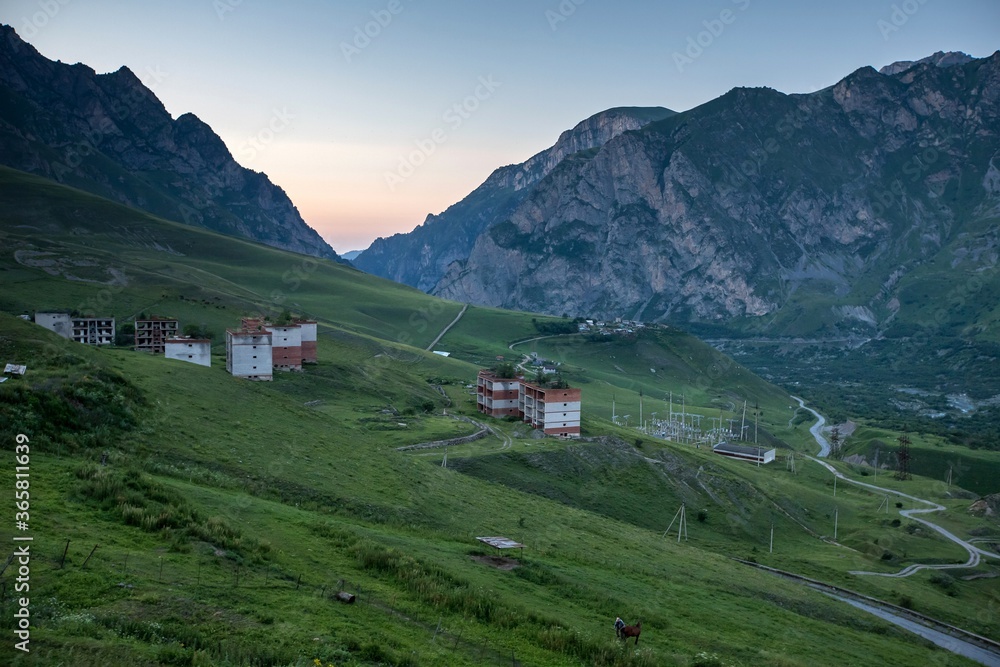Beautiful green Caucasus mountains, Karmadonskoe gorge and hotel abandoned after tragedy when the Kolka glacier claimed the lives of hundreds of people in 2002.