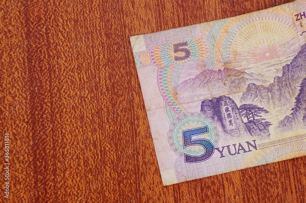 Obraz premium 5 Yuan Chinese banknote close up on wooden background.