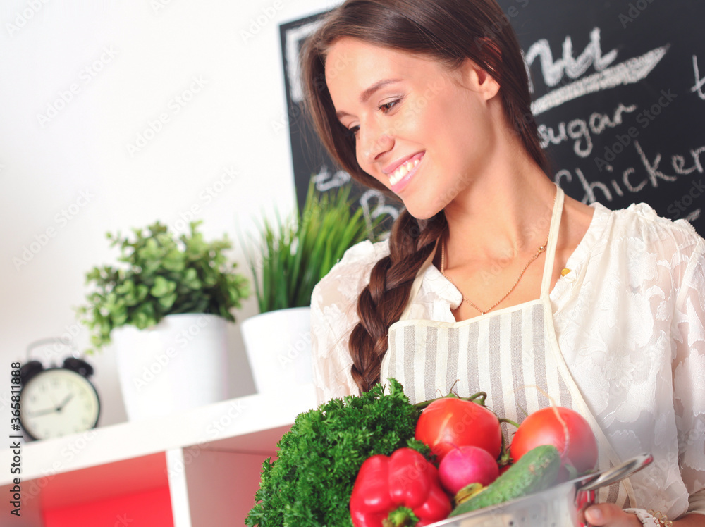 Young woman cooking in the kitchen. Young woman Young woman cooking in the kitchen. Young woman