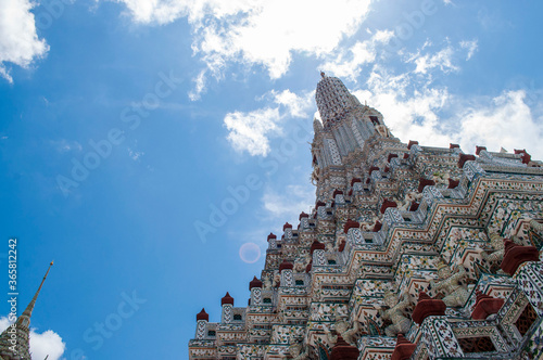 Wat Arun Buddhist Temple in Bangkok Thailand.A diagonal view from the base of the chedi in the near distance to Wat Arun photo