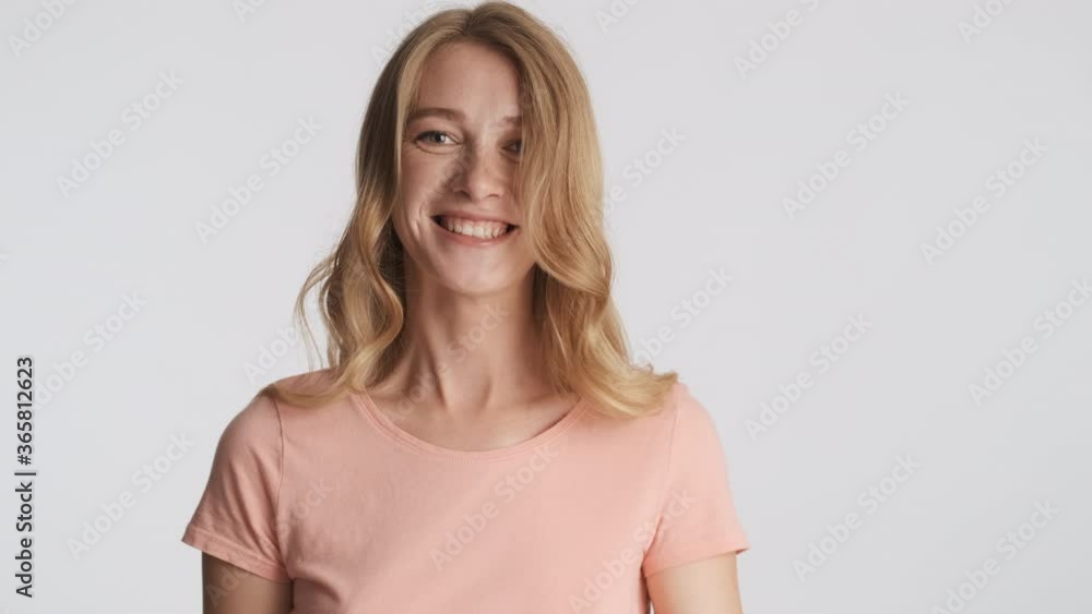 Pretty cheerful blond girl joyfully waving yes on camera over gray background. Agree expression Pretty cheerful blond girl joyfully waving yes on camera over gray background. Agree expression