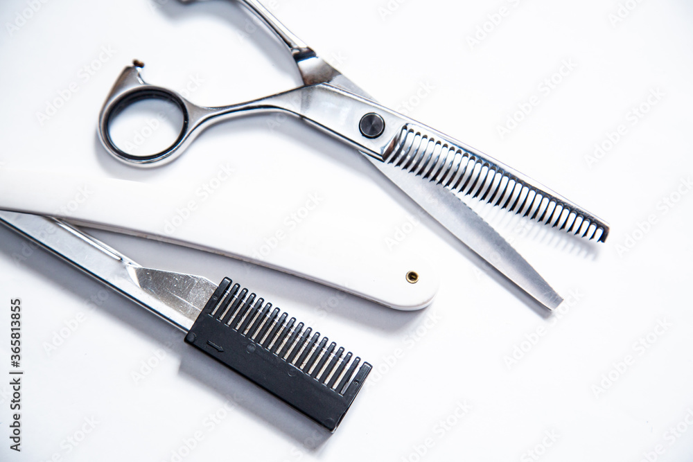 Professional tools for hairdresser, barber. Scissors, blade, comb on a white background. Professional tools for hairdresser, barber. Scissors, blade, comb on a white background.