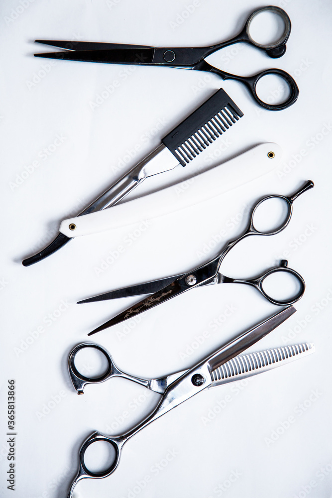 Professional tools for hairdresser, barber. Scissors, blade, comb on a white background. Professional tools for hairdresser, barber. Scissors, blade, comb on a white background.