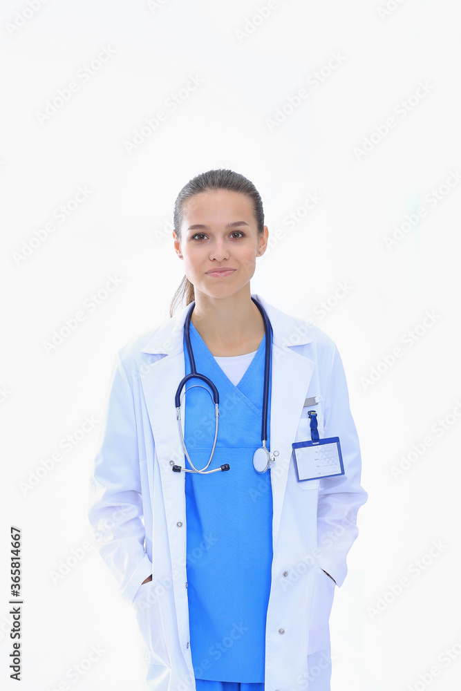Beautiful young woman in white coat posing with hand in pocket. Woman doctor