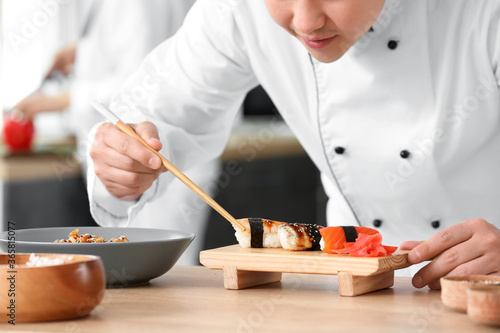 Handsome Asian chef cooking...