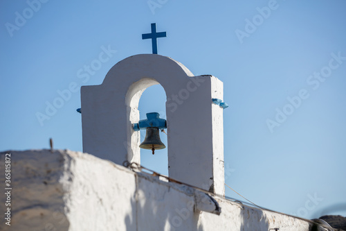 Small church belfry detail, white and blue colors on clear blue sky background. Greece. Kea island. photo