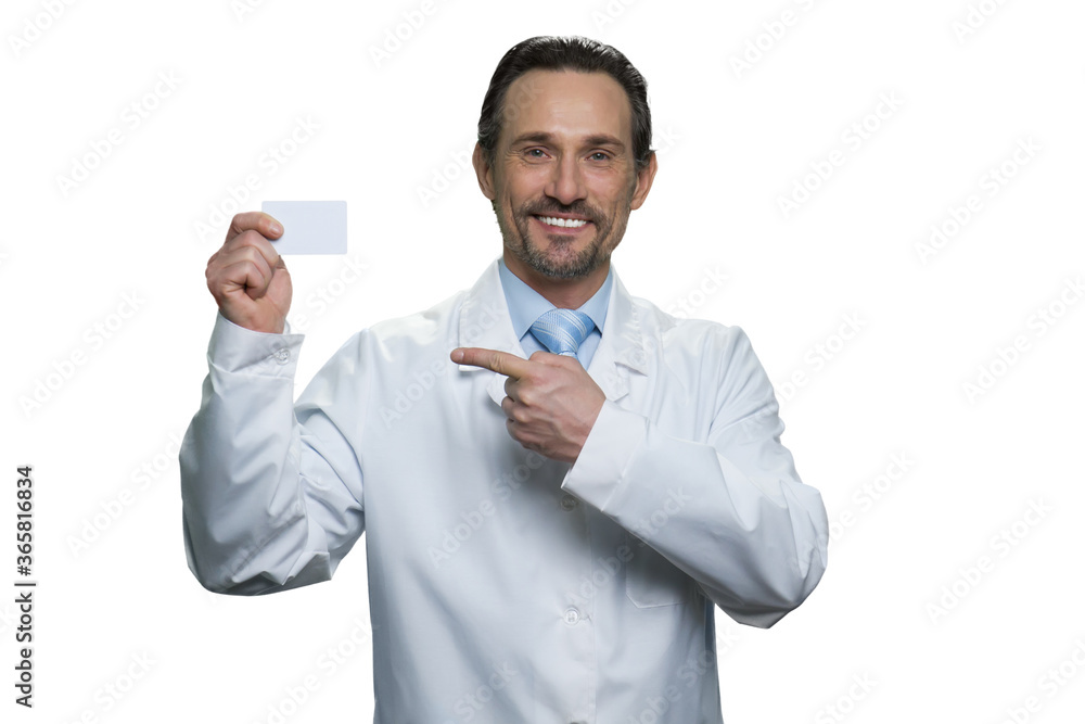 Handsome mature doctore pointing at the card. Portrait of smiling caucasian doctor isolated on white background. Handsome mature doctore pointing at the card. Portrait of smiling caucasian doctor isolated on white background.