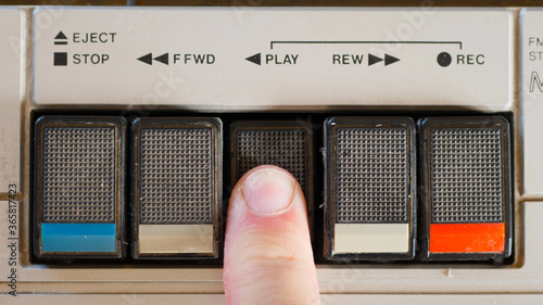 Pressing Play Button on a Retro Cassette Player